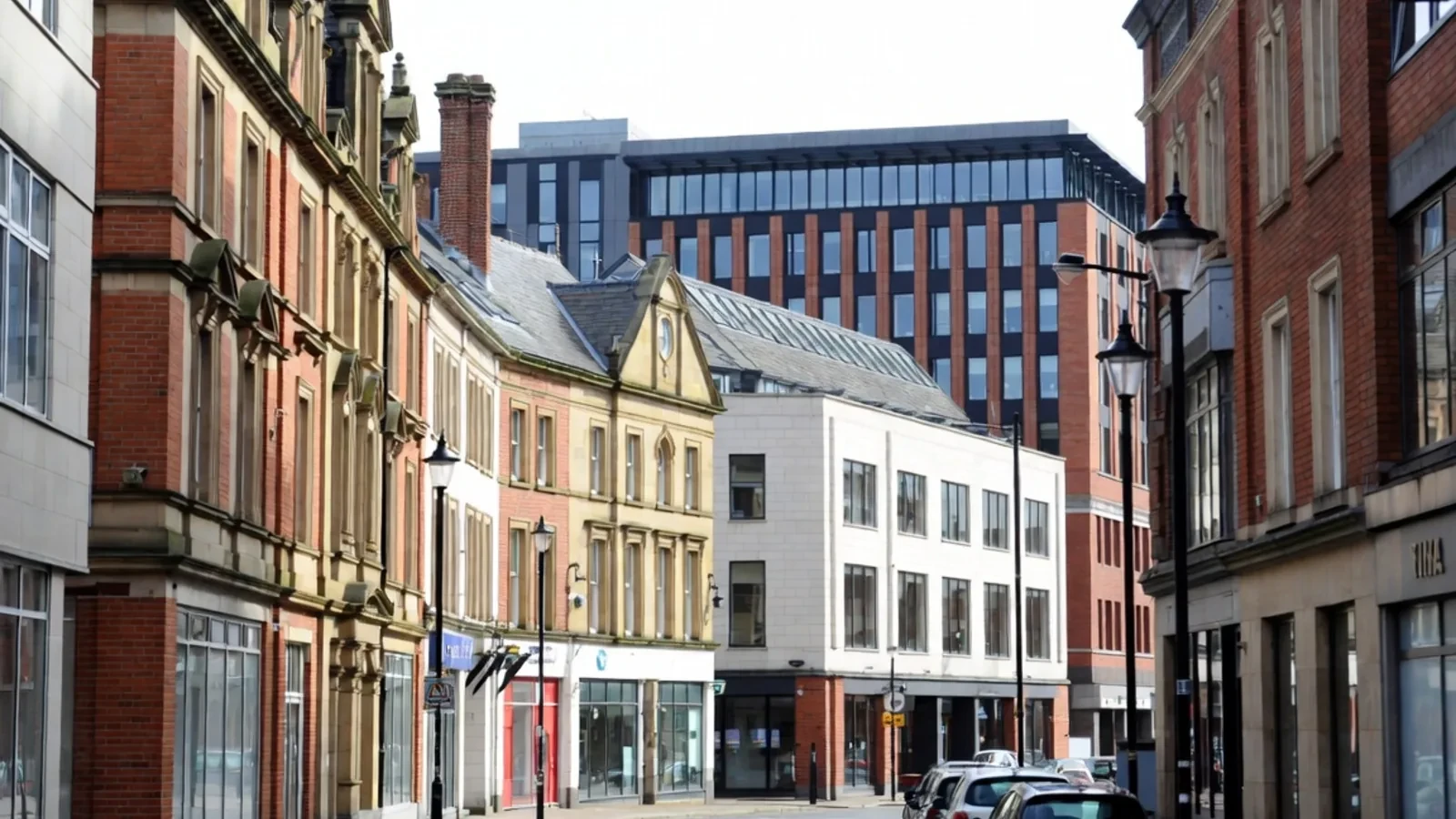 City-centre street with commercial premises beneath upper floors