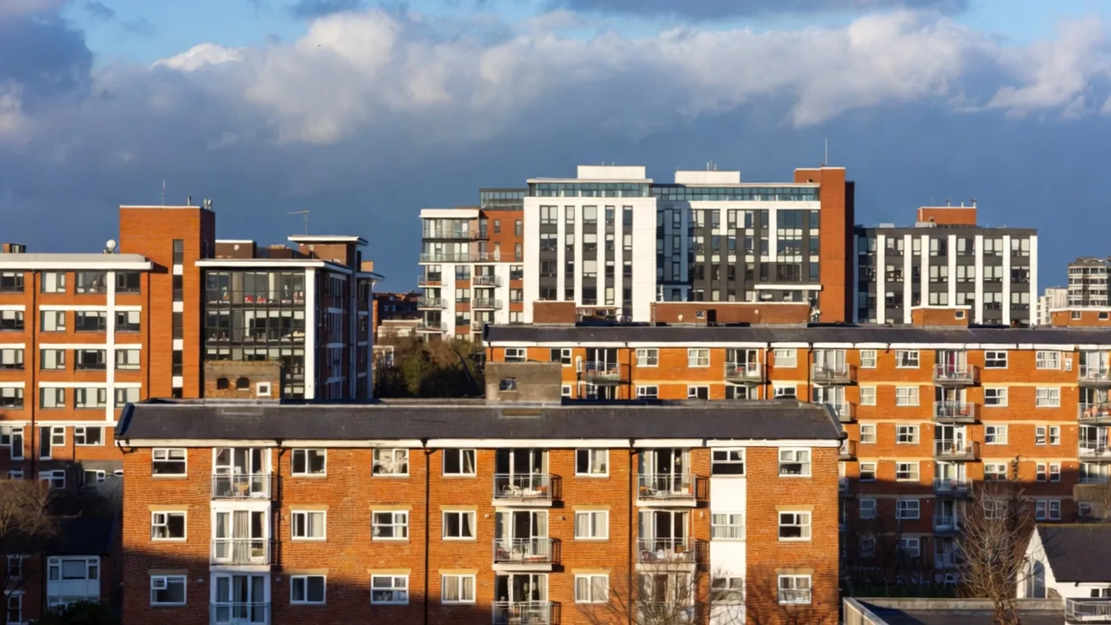 Brick apartment blocks with city skyline